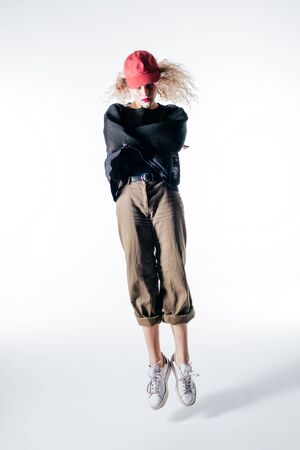 Young beautiful female dancer is posing in the studio