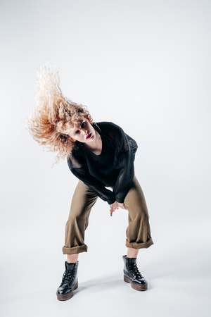 Young beautiful female dancer is posing in the studioの写真素材