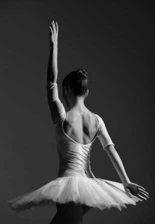 Young beautiful ballerina is posing in studioの写真素材
