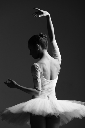 Young beautiful ballerina is posing in studioの写真素材