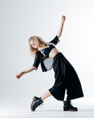 Young beautiful female dancer is posing in the studioの写真素材