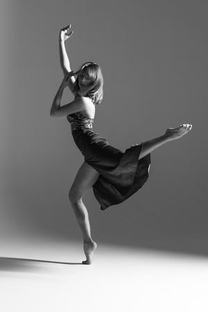Young beautiful ballerina is posing in studioの写真素材