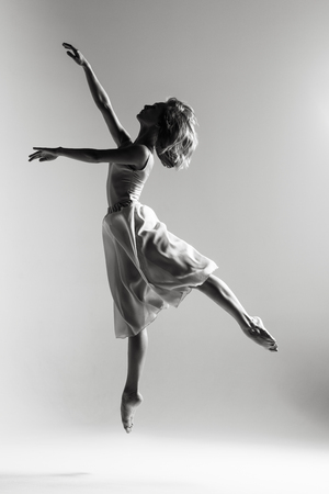 Young beautiful ballerina is posing in studioの写真素材
