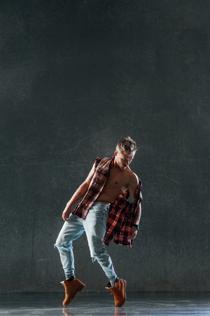 Young beautiful male dancer posing in studioの写真素材