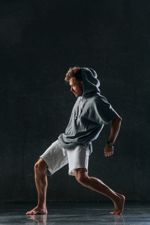Young beautiful male dancer posing in studioの写真素材
