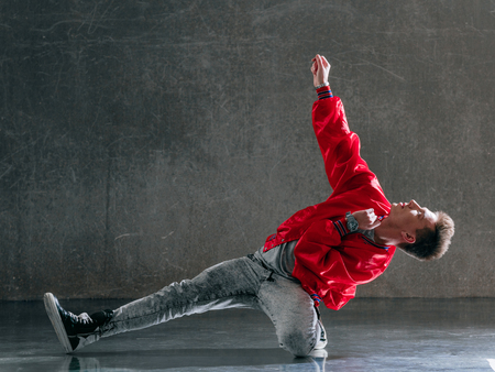 Young beautiful male dancer posing in studio