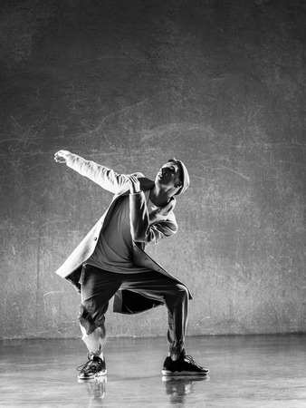 Young beautiful male dancer posing in studioの写真素材