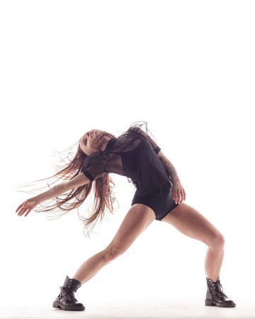 Young beautiful dancer is posing in studioの写真素材