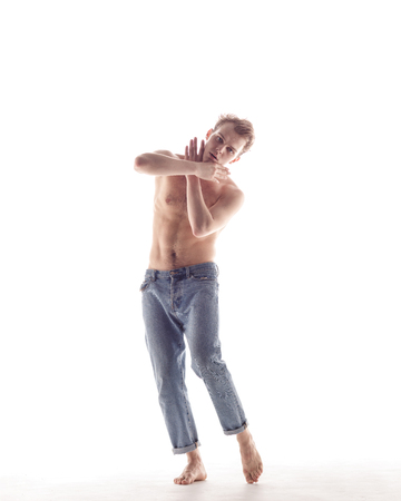 Young beautiful dancer is posing in studioの写真素材