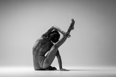 Young beautiful yoga woman is posing in studio. Black and whiteの写真素材