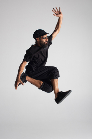 Hip hop dancer moving and jumping in photostudioの写真素材