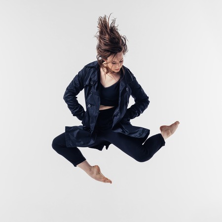 Young beautiful dancer posing in studioの写真素材