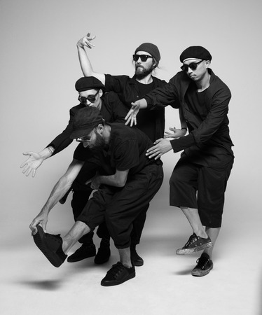 Hip hop dancers moving and jumping in photostudioの写真素材