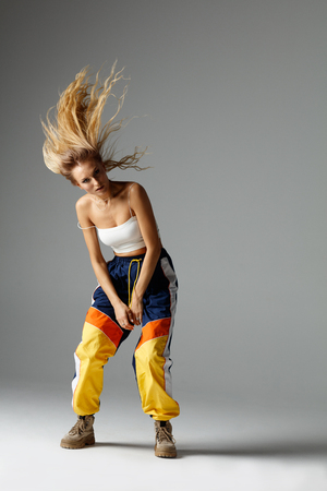 Hip hop dancer moving and jumping in studioの写真素材