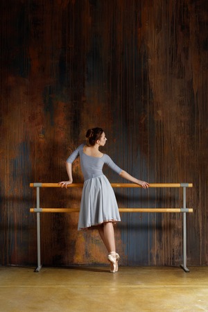 Young beautiful ballerina is posing in studioの写真素材