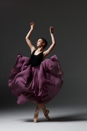 Young beautiful ballerina is posing in studioの写真素材