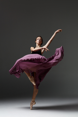 Young beautiful ballerina is posing in studioの写真素材