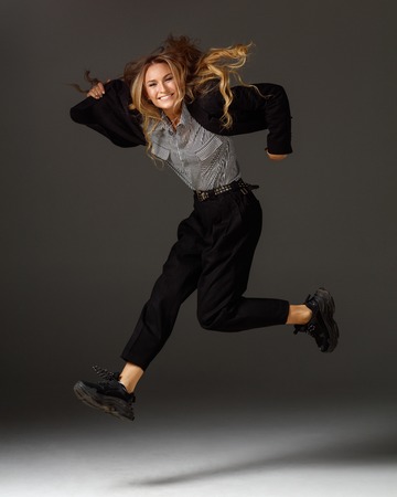Young beautiful female dancer is posing in the studioの写真素材