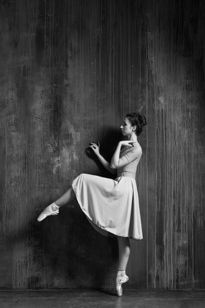 Young beautiful ballerina is posing in studioの写真素材