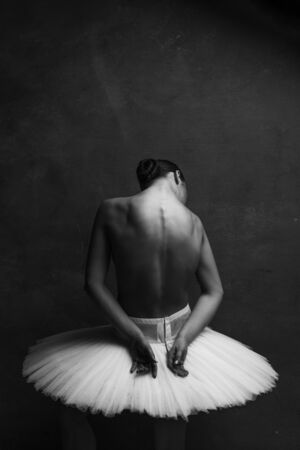 Young beautiful ballet dancer is posing in studioの写真素材