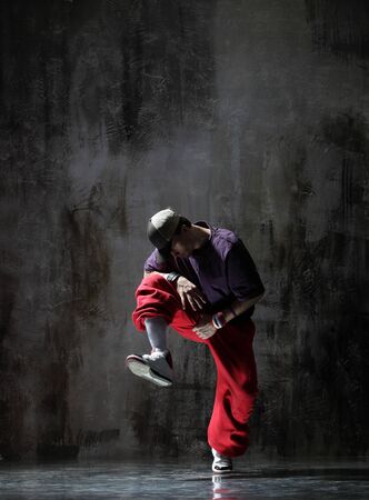cool looking dancer posing on a grunge backgroundの写真素材