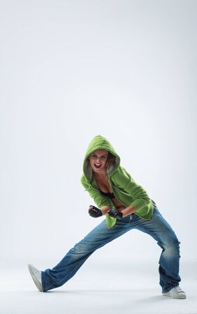 young woman jumping on studio backdropの写真素材