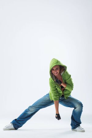 young woman jumping on studio backdropの写真素材