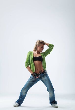young woman jumping on studio backdropの写真素材