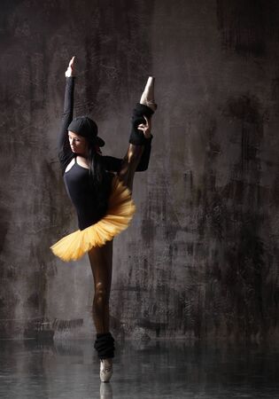 Young beautiful ballerina is posing in studioの写真素材