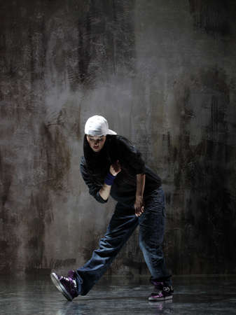 modern style dancer posing on dirty grunge backgroundの写真素材