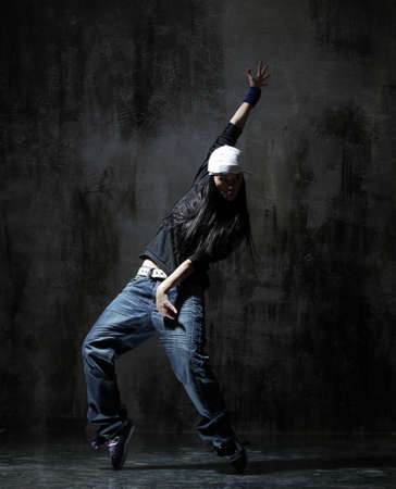 modern style dancer posing on dirty grunge backgroundの写真素材