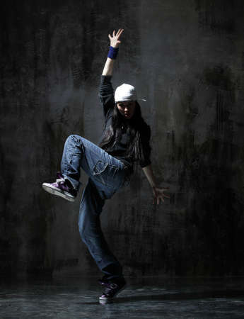 modern style dancer posing on dirty grunge backgroundの写真素材