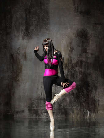 modern style dancer posing on dirty grunge backgroundの写真素材