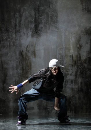 modern style dancer posing on dirty grunge backgroundの写真素材