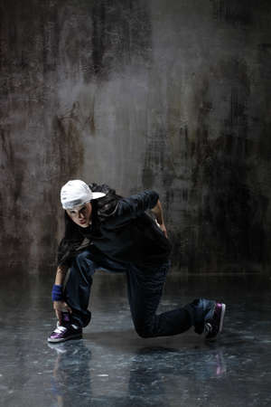 modern style dancer posing on dirty grunge backgroundの写真素材
