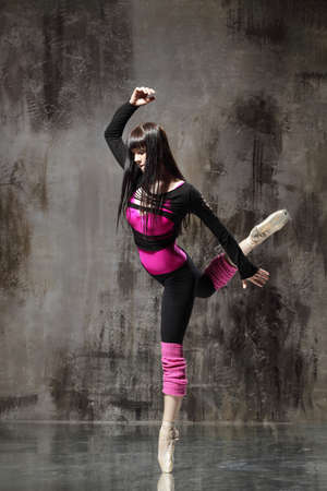 modern style dancer posing on dirty grunge backgroundの写真素材