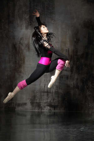 modern style dancer posing on dirty grunge backgroundの写真素材