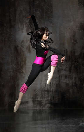 modern style dancer posing on dirty grunge backgroundの写真素材