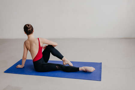 Young beautiful yoga woman is posing in studio.
