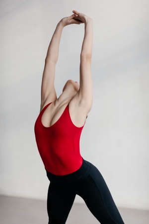 Young beautiful yoga woman is posing in studio.の写真素材