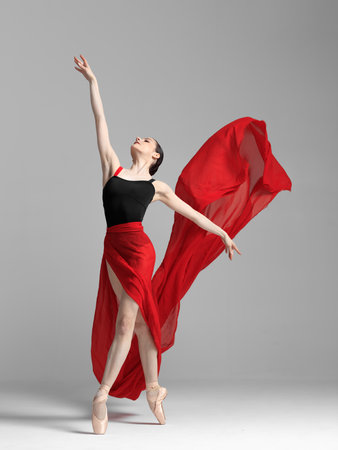 Young beautiful skinny ballerina is posing in studioの写真素材