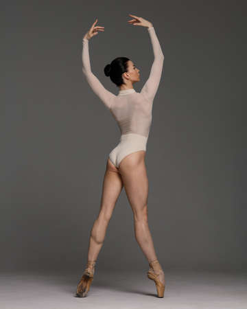 Young beautiful skinny ballerina is posing in studioの写真素材