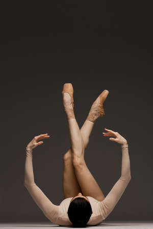 Young beautiful skinny ballerina is posing in studioの写真素材