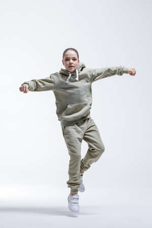 Young beautiful cool looking girl posing in studioの写真素材
