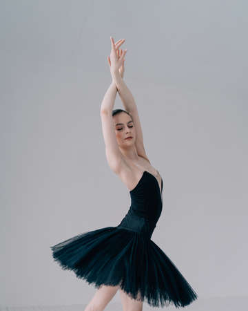 Young beautiful ballerina is posing in studioの写真素材