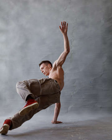 Young beautiful cool looking bboy posing in studioの写真素材