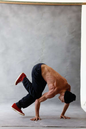 Young beautiful cool looking bboy posing in studioの写真素材