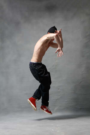 Young beautiful cool looking bboy posing in studioの写真素材