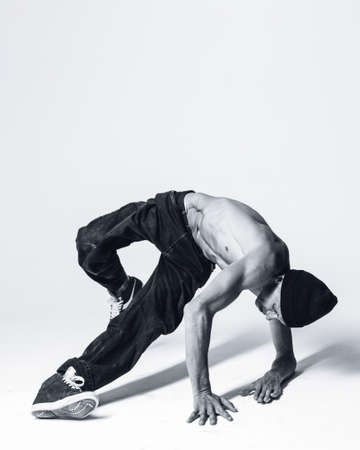 Young beautiful cool looking bboy posing in studioの写真素材