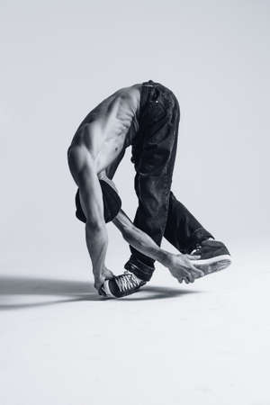 Young beautiful cool looking bboy posing in studioの写真素材
